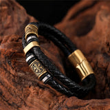 Pulsera de cuero negro trenzado con dije dorado
